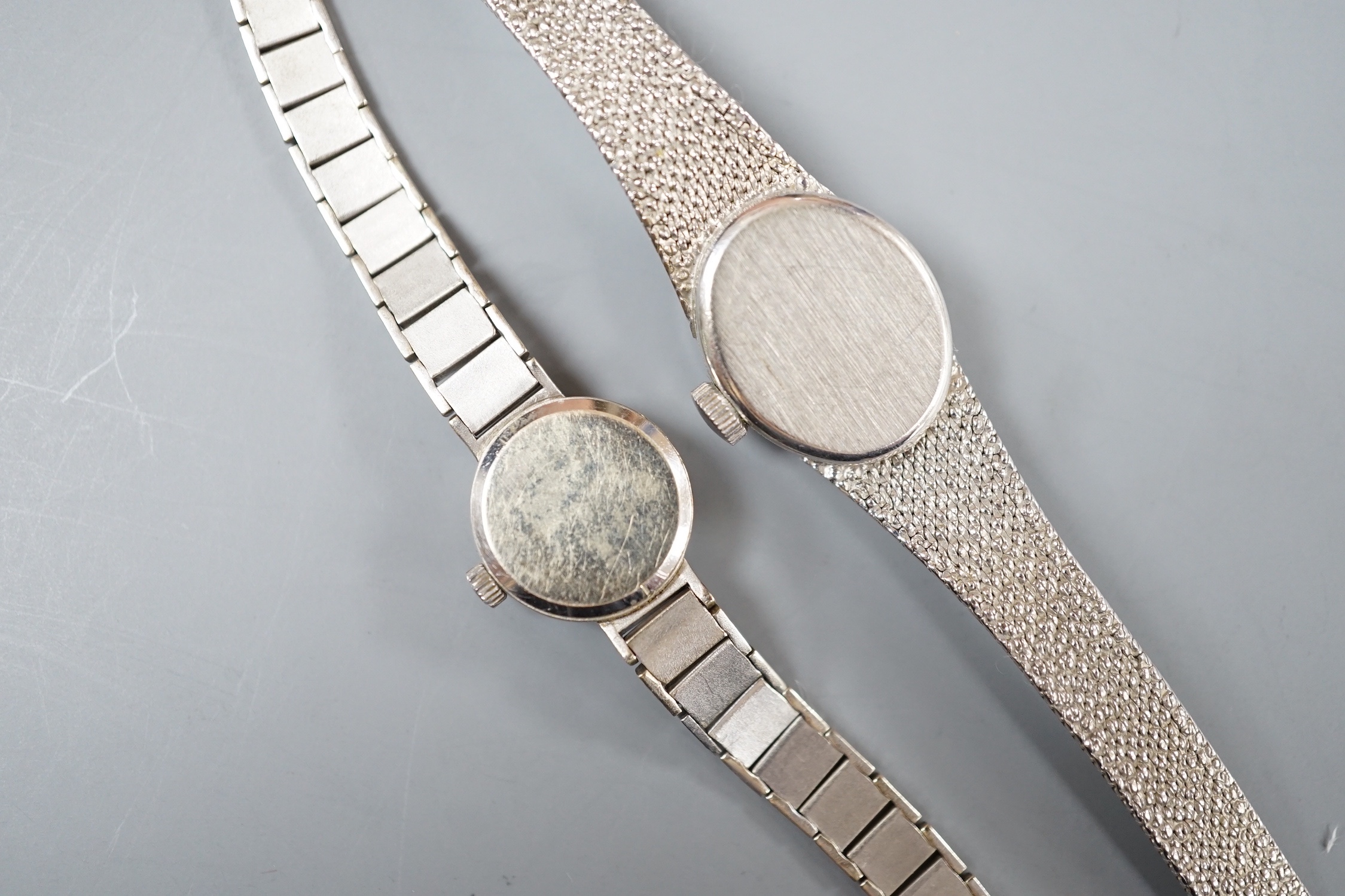 A lady's 9ct white gold Rotary manual wind wrist watch and a similar Omega wrist watch, gross 31.5 grams.